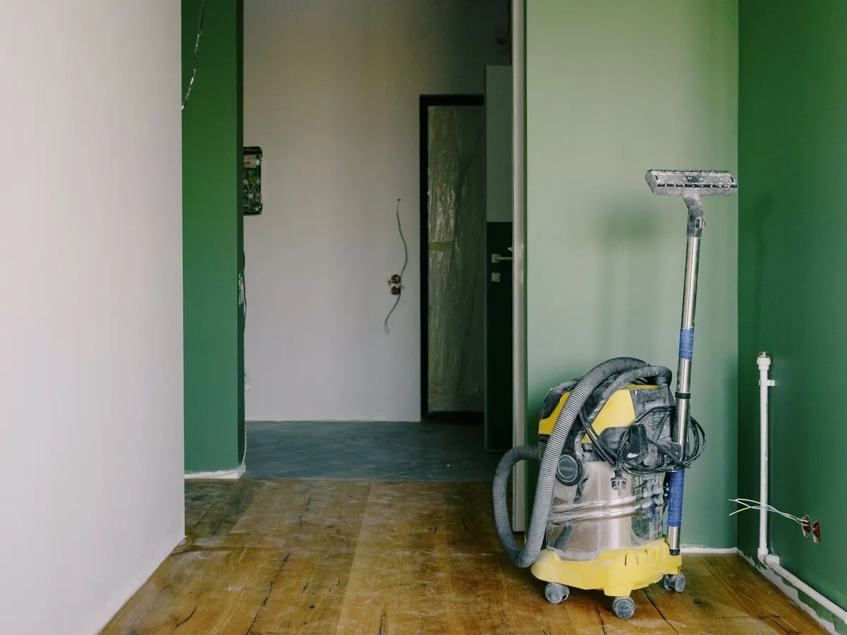 Vacuum cleaner in an empty room after renovation work